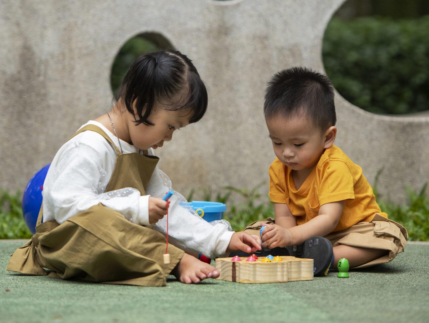 children playing at a playrgound outside.