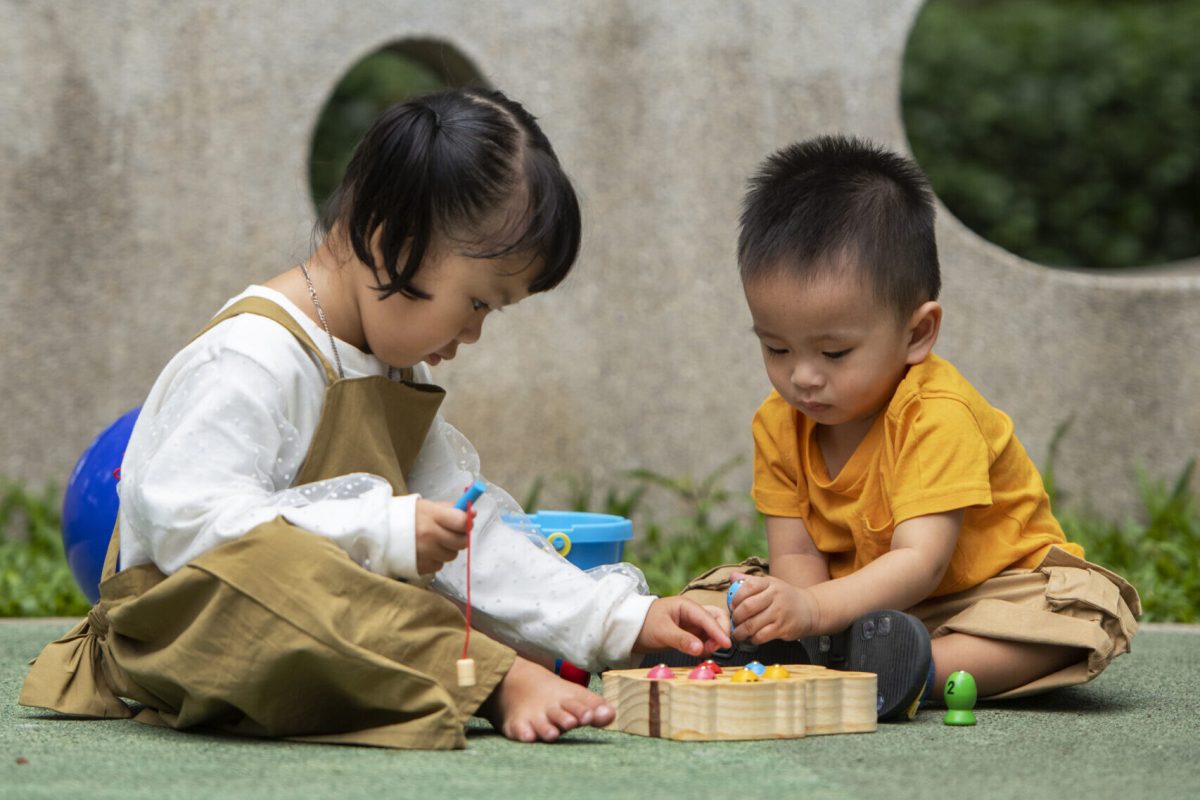 children playing at a playrgound outside.